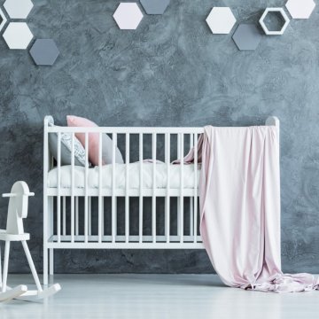 white baby crib in a grey nursery